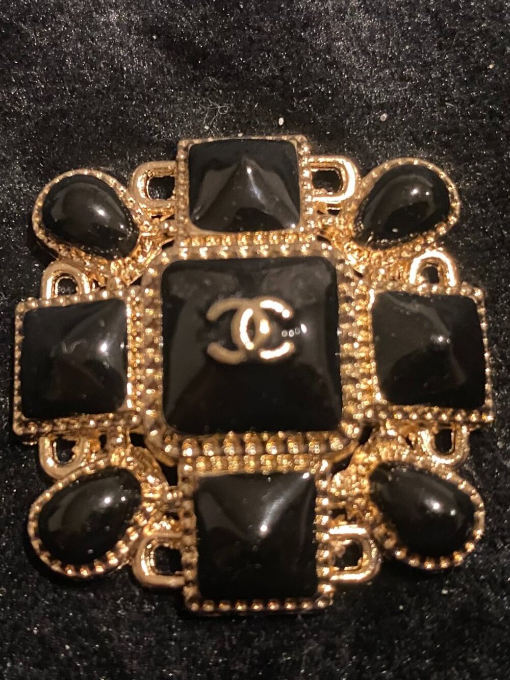 CC Gold tone with black accents emblem